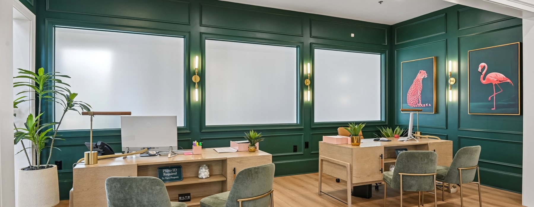 a room with a desk and chairs